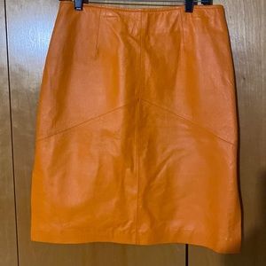 Smart and sexy orange leather skirt with side slits! Excellent Condition!